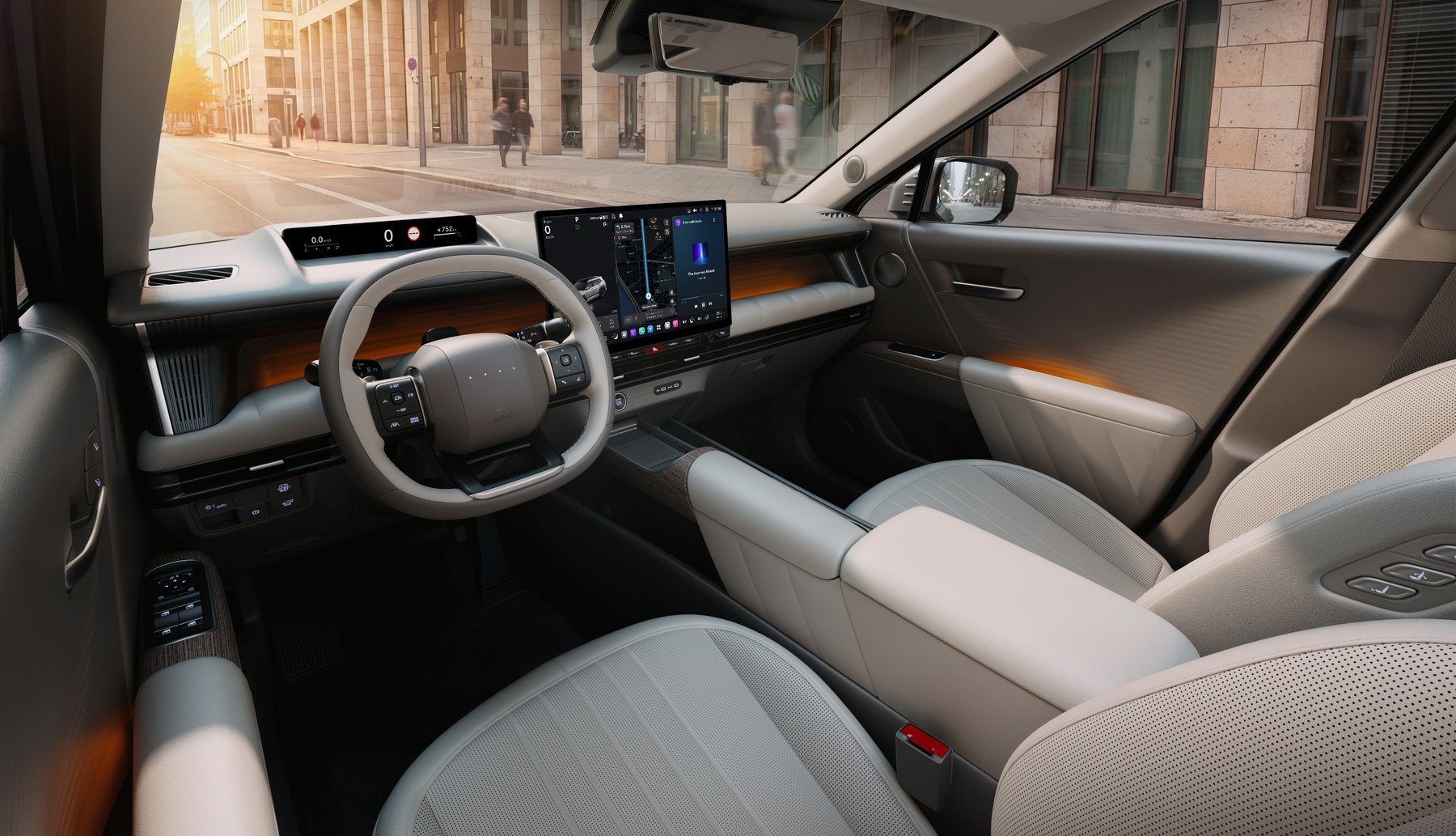 Interior del nuevo Hyundai Tucson 2027 con tapicería clara, volante de doble D y la pantalla central de gran formato